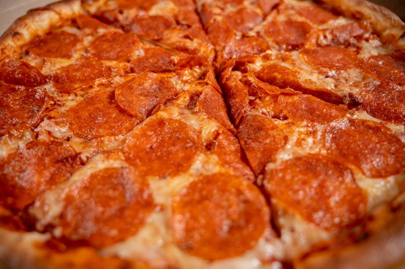 Classic pepperoni green lantern pizza with golden crust